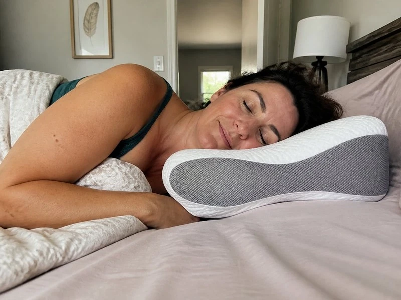 Denise, 48, sleeping on her side using the pillow