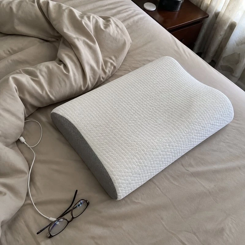 Pillow on a made bed, overhead customer photo